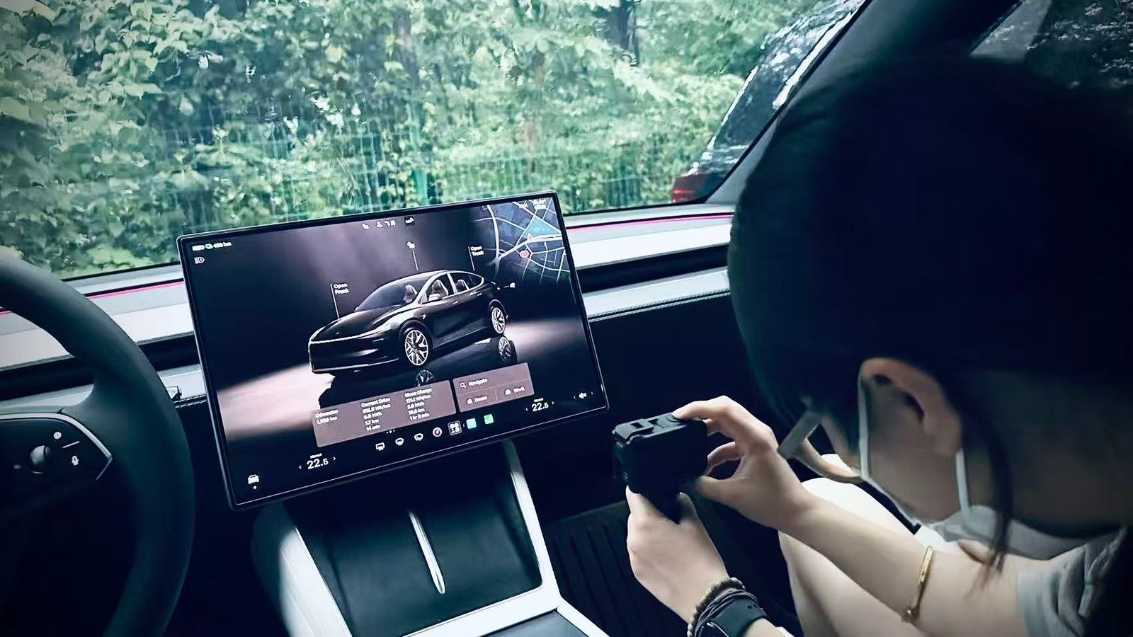 Autolind founder photographing an installed EV screen protector inside a vehicle.