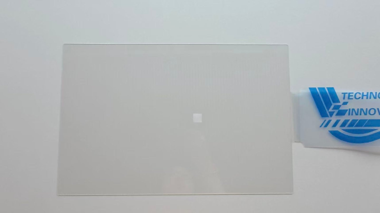 Autolind inspecting a high-alumina glass screen protector sample before product approval.