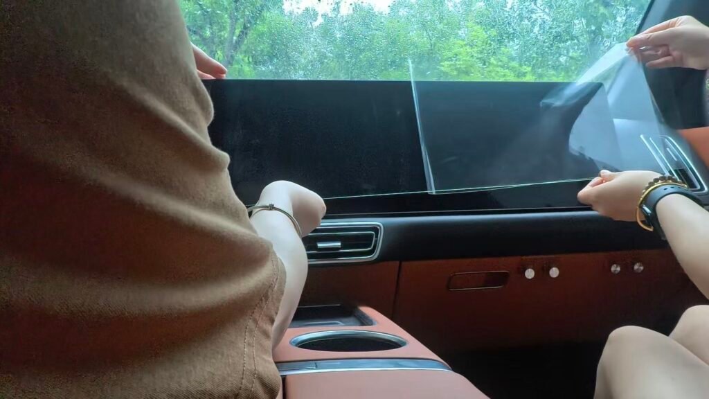 Peeling off half of the release film before installing an EV screen protector